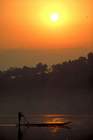 Paddling fisherman in Buon-Ma-Tuot at sunrise